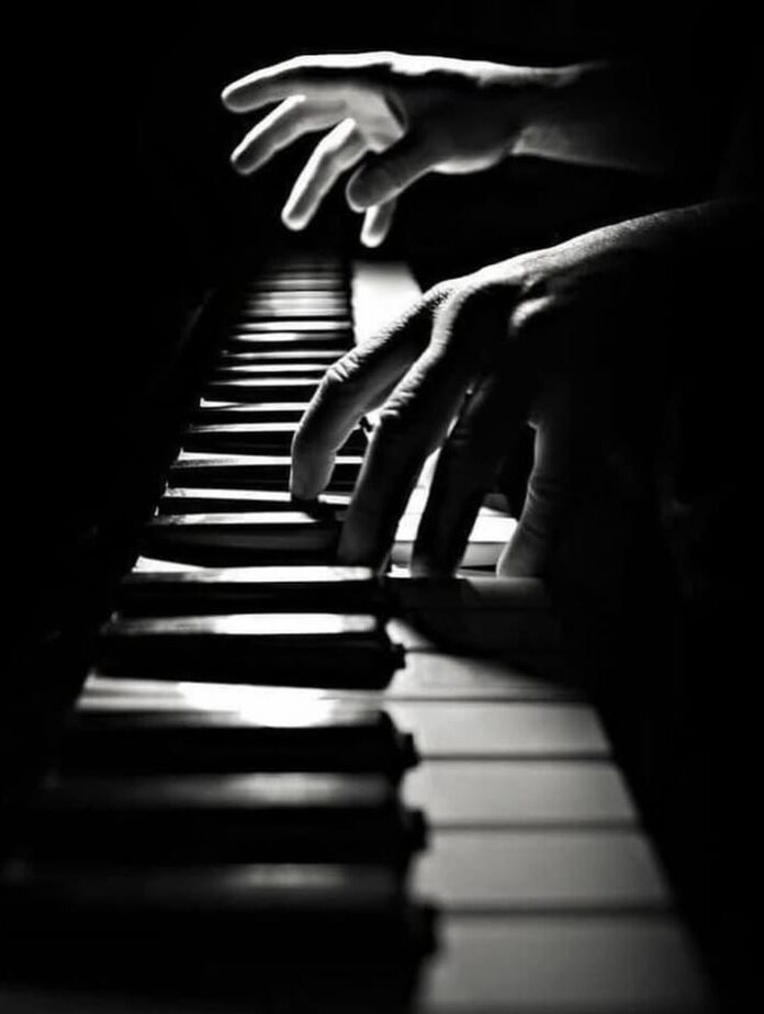 Two hands on a piano keyboard during focused practice